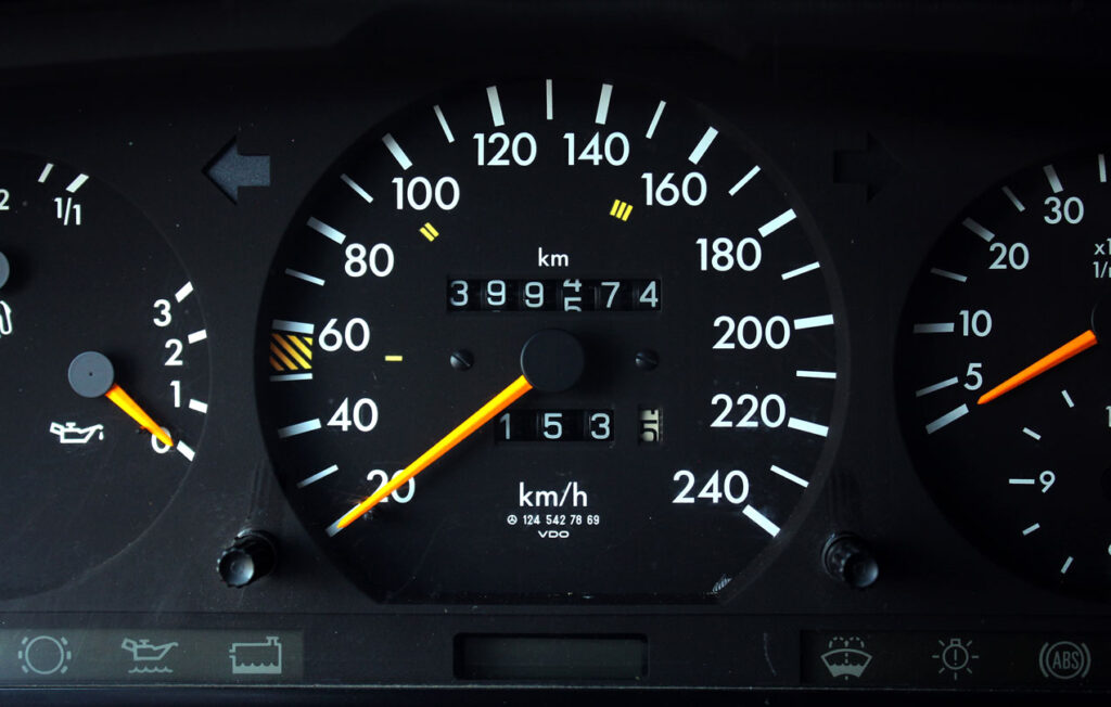 Old car speedometer with high mileage. Dashboard of oldschool car. Old car dashboard.